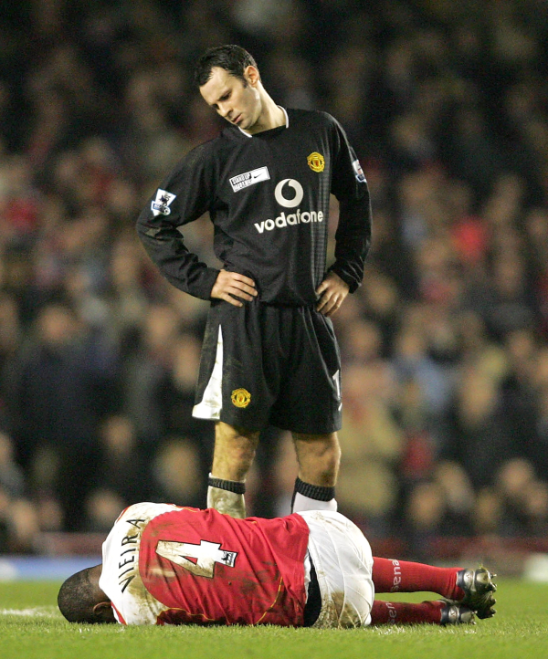 LONDON, ENGLAND - FEBRUARY 1: Patrick Vieira of Arsenal lies on the ground while Ryan Giggs of Manchester United down at him during the Barclays Premiership match between Arsenal and Manchester United at Highbury on February 1 2005 in London, England. (Photo by John Peters/Manchester United via Getty Images) *** Local Caption *** Patrick Vieira;Ryan Giggs