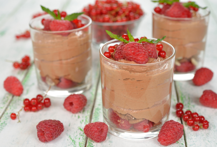Chocolate mousse with raspberries on a white background