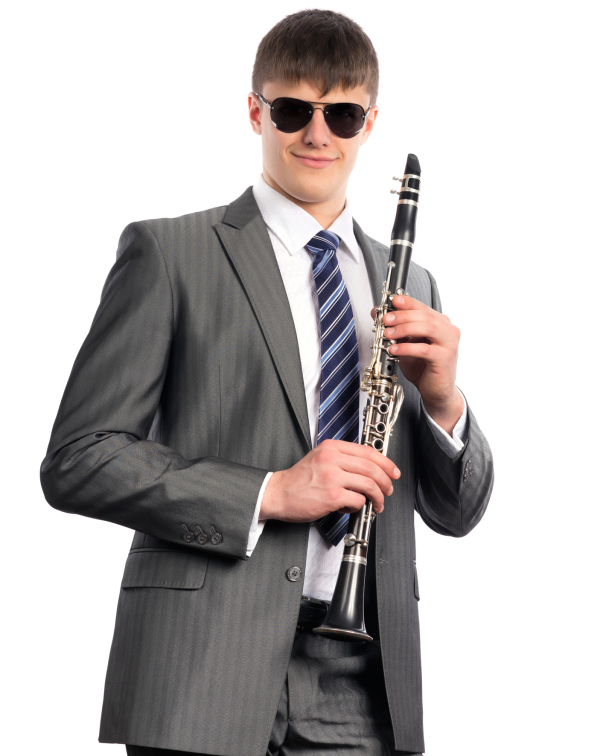 Young musician plays the clarinet on a white background