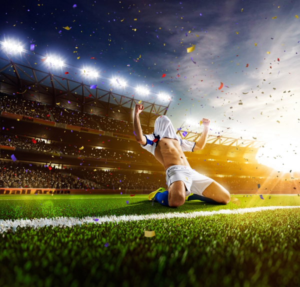 Soccer player in action on sunny stadium background