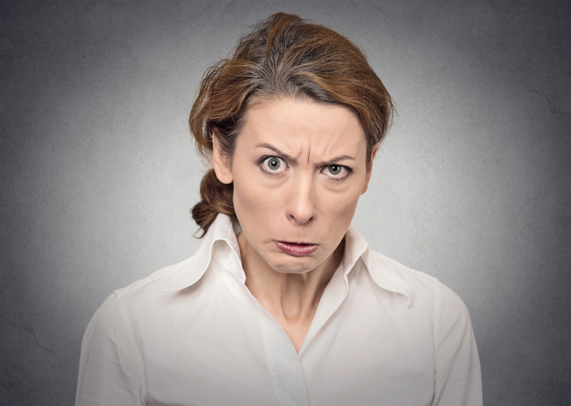 portrait angry woman on grey background 