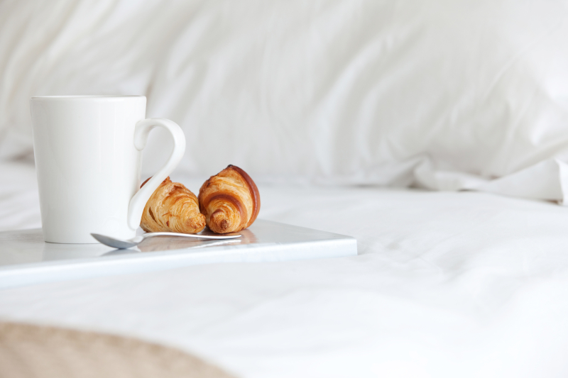 Tray with breakfast on a bed