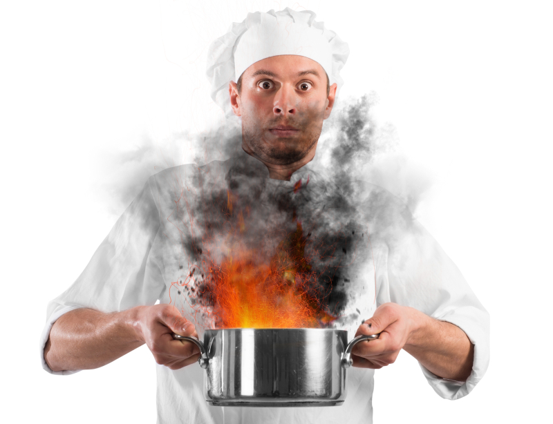 Chef shocked holding a pot with flames