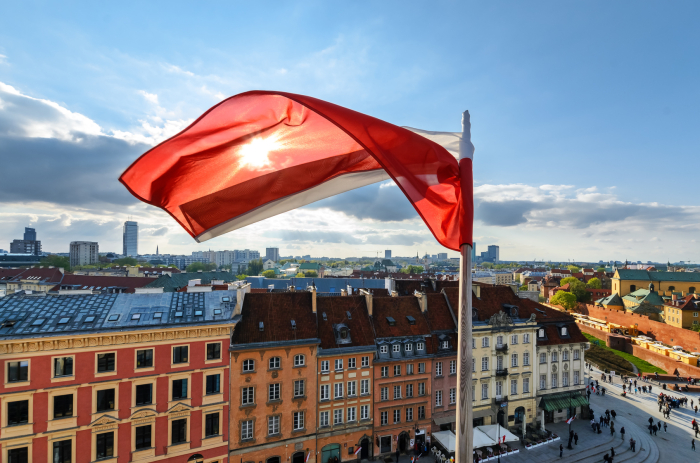 Poland Flag on Blue Sky and centre of Warsaw Background