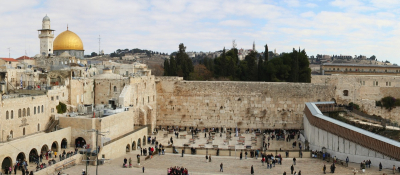 Western Wall in the Old City of Jerusalem, the most important jewish religious site with al-Aqsa mosque (right) and Dome of the Rock (left) on the background.