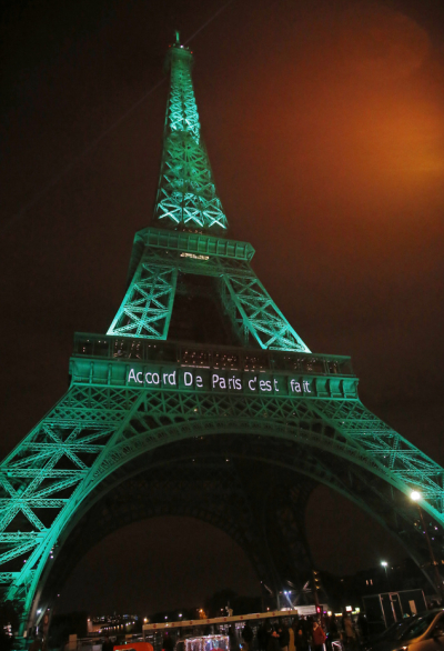 The Eiffel Tower lit up in green to mark the success of the Paris Agreement, Friday Nov.4, 2016 in Paris. The Paris Agreement on climate change enters into force Friday faster than anyone had anticipated, after a year with remarkable success in international efforts to slash man-made emissions of carbon dioxide and other global warming gases. Inscription reads, 