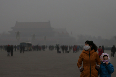 BEIJING, CHINA - JANUARY 23: A tourist and her daughter wearing the masks visit the Tiananmen Square at dangerous levels of air pollution on January 23, 2013 in Beijing, China. The air quality in Beijing on Wednesday hit serious levels again, as smog blanketed the city. (Photo by Feng Li/Getty Images)