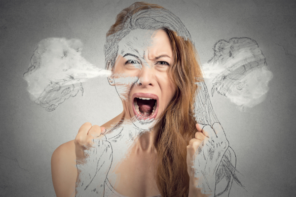 Closeup portrait angry young woman blowing steam coming out of ears having nervous breakdown hysterical screaming isolated grey background. Negative human emotion facial expression feeling attitude
