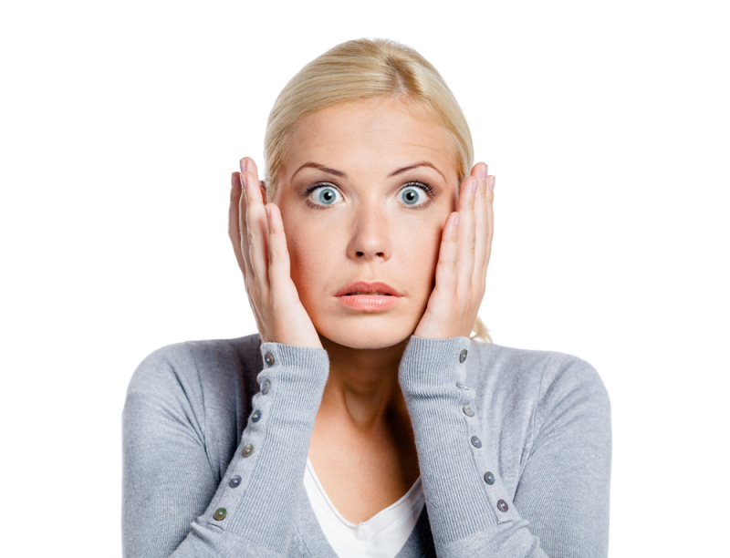 Shocked woman puts hands on her head, isolated on white