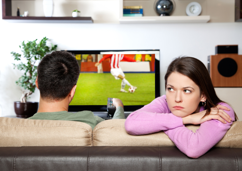 Image of woman getting bored, while her partner watching sports
I am the author of image on TV screen
