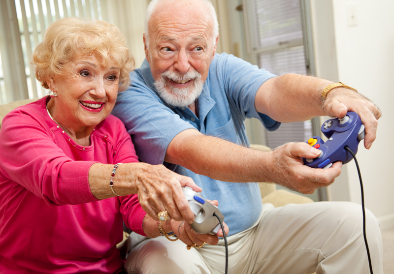 Senior couple having fun playing video games.