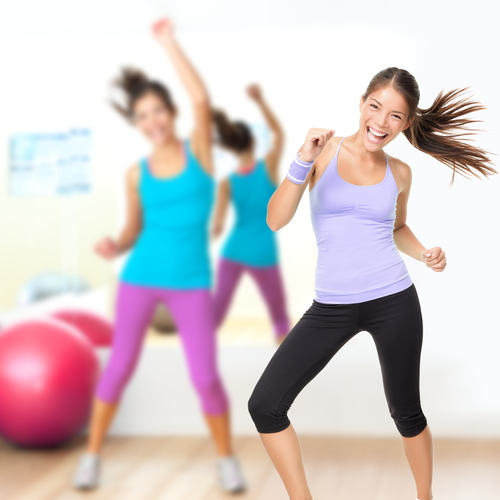 Fitness dance studio zumba class. Dancing woman in gym during exercise dancer workout training with happy fresh energy.