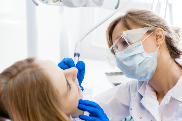 Young Professional Woman Dentist working with a Female Patient